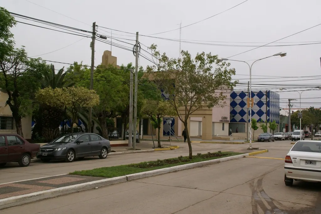 The blue-and-white diamond facade of Casino Corral de Bustos seen across the boulevard — Casino Corral de Bustos